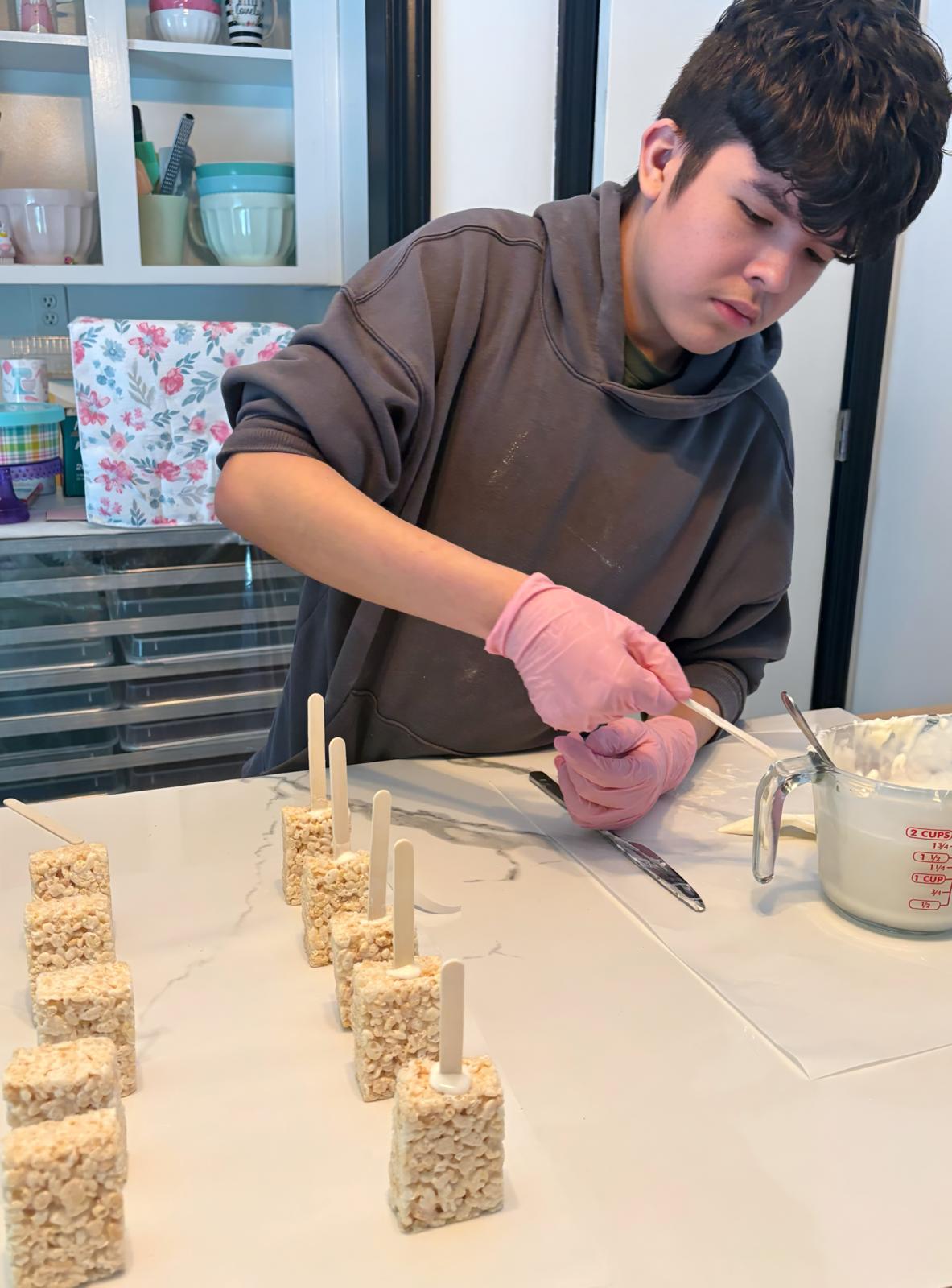 Mathias carefully making treats by hand