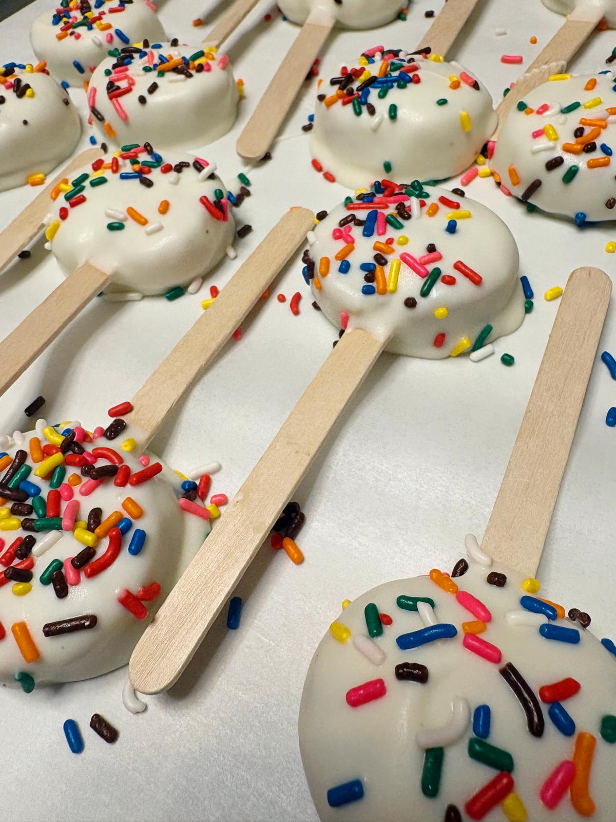 Colorful sprinkle-covered cakesicles from Mathias Treats